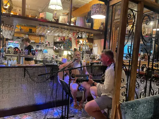 Will and Steph performing beside the bar