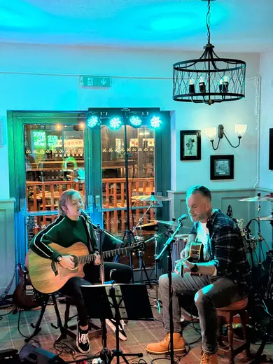 Singing under turquoise lights