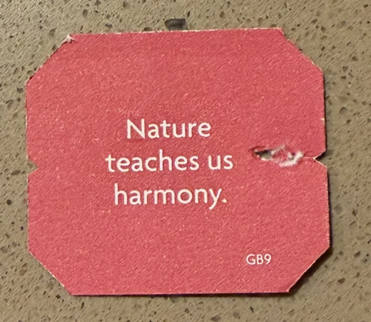 A red tag reading Nature teaches us harmony.